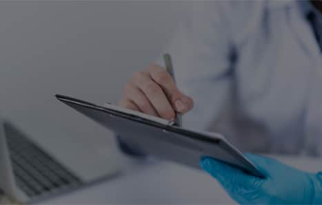 A nurse recording notes on a medical chart